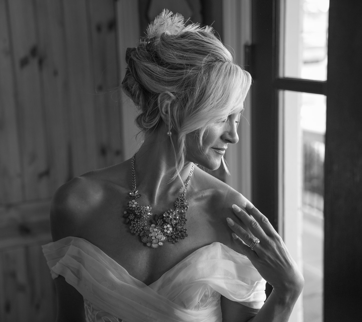 Bride by a window in black and white