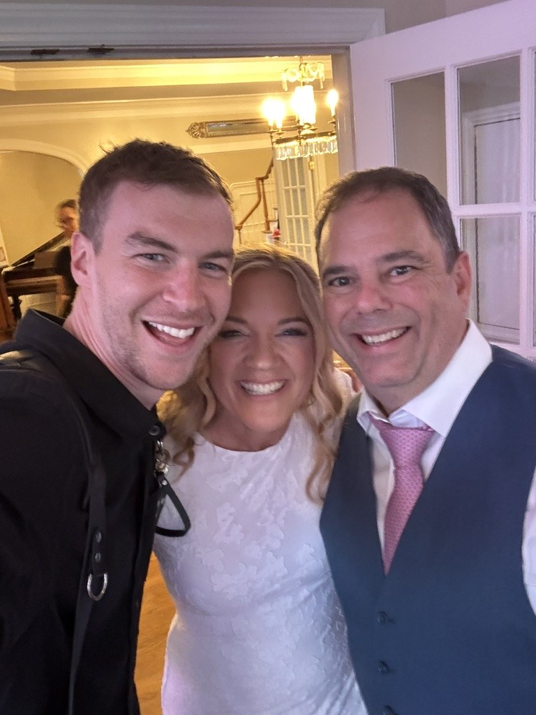 Ben with a bride and groom