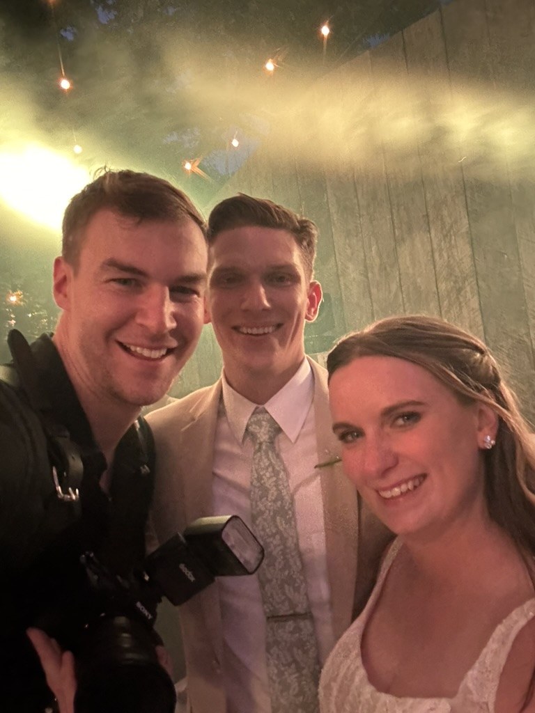 Ben with a bride and groom